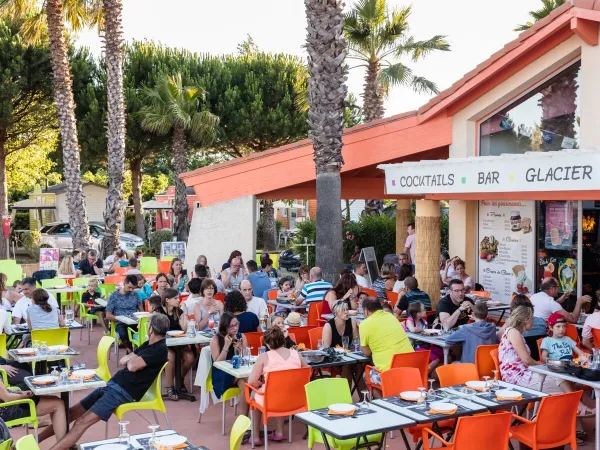 Gezellig terras bij de bar op Roan camping Les Sablines.